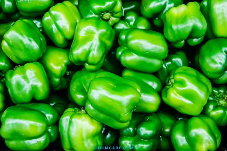 Fresh green bell peppers with shiny skin.